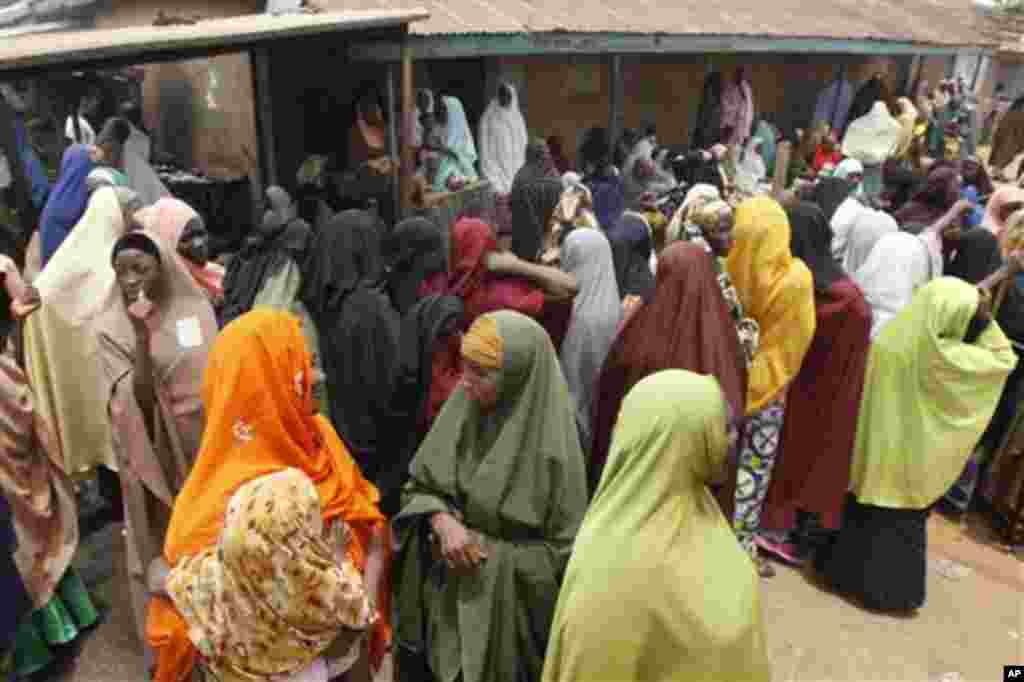 Women gather as the wait to cast their votes in Kaduna, Nigeria, Thursday, April 28, 2011. Two states in Nigeria's Muslim north voted Thursday for state gubernatorial candidates after their polls were delayed by violence that killed at least 500 last wee