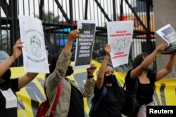 People protest against a new criminal code in Jakarta