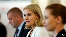 Denmark's Social Democrats, headed by Prime Minieter Helle Thorning-Schmidt, center, Minister of Finance Bjarke Corydon, left, and Minister of Justice Mette Frederiksen, attend press conference, Copenhagen, June 17, 2015.
