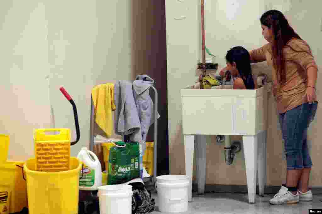 A woman from Central America bathes a child at the "House of the Refugee," which gives temporary shelter to migrants released by ICE and U.S. Customs and Border Protection (CBP) due to overcrowded facilities, in El Paso, Texas, April 24, 2019.