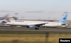 FILE - The Metrojet's Airbus A321 with registration number EI-ETJ that crashed in Egypt's Sinai Peninsula, takes off from Moscow's Domodedovo airport, Russia, Oct. 20, 2015.