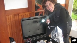 Dr. Laura Stachel with a 'solar suitcase,' which powers two overhead LED lighting, charges walkie-talkies and cell phones and includes LED headlamps that come with their own rechargeable batteries.