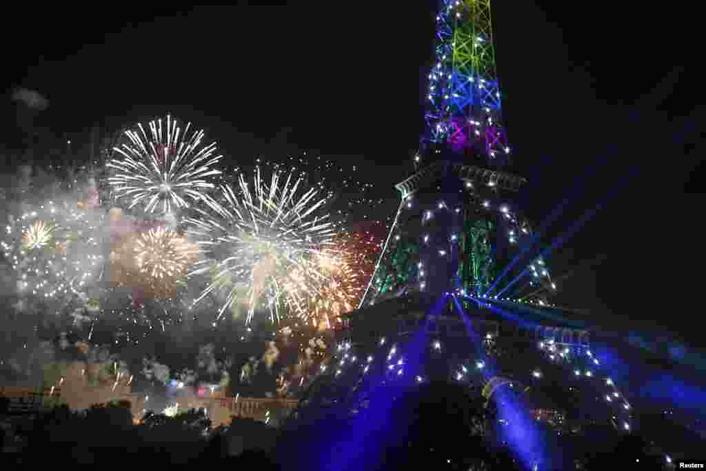 The Eiffel Tower is illuminated during the traditional Bastille Day fireworks display in Paris, July 14, 2013. 