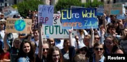 Youths hold a banner as they demonstrate calling for action on climate change during the "Fridays for Future" school strike, on Heldenplatz in Vienna, Austria, May 24, 2019.