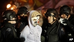 Police arrest an Occupy Los Angeles protester at the encampment at city hall November 30, 2011.