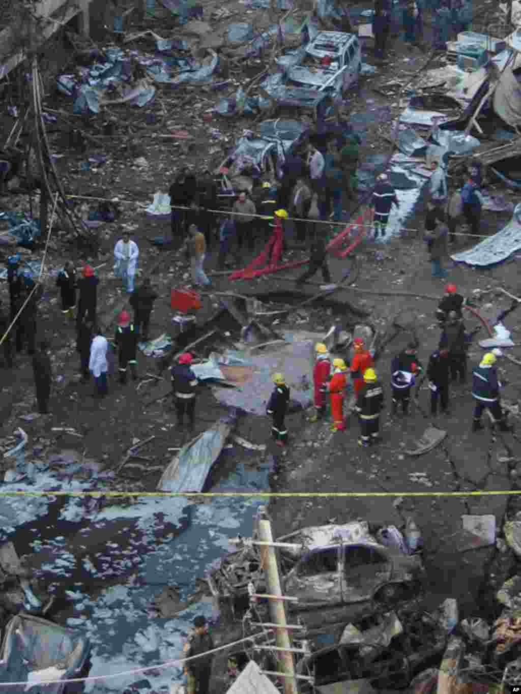 Iraqi security forces inspect a crater caused by one of several bomb attacks across Baghdad on December 22, 2011. (AP)