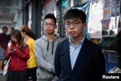 Disqualified candidate and pro-democracy activist Joshua Wong stands in line to vote in the district council elections in Hong Kong, Nov. 24, 2019.