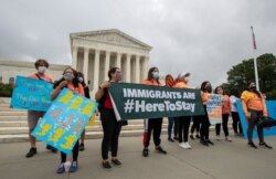 FILE - In this June 18, 2020, photo, Deferred Action for Childhood Arrivals students celebrate in front of the Supreme Court in Washington after it rejected President Donald Trump's effort to end legal protections for young immigrants.