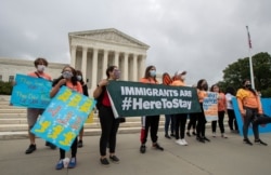 FILE - Deferred Action for Childhood Arrivals supporters celebrate in front of the Supreme Court after it rejected then-President Donald Trump's effort to end legal protections for young immigrants, in Washington, June 18, 2020.