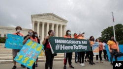 In this June 18, 2020, photo, Deferred Action for Childhood Arrivals (DACA) students celebrate in front of the Supreme Court after the Supreme Court rejected President Donald Trump's effort to end legal protections for young immigrants in Washington…