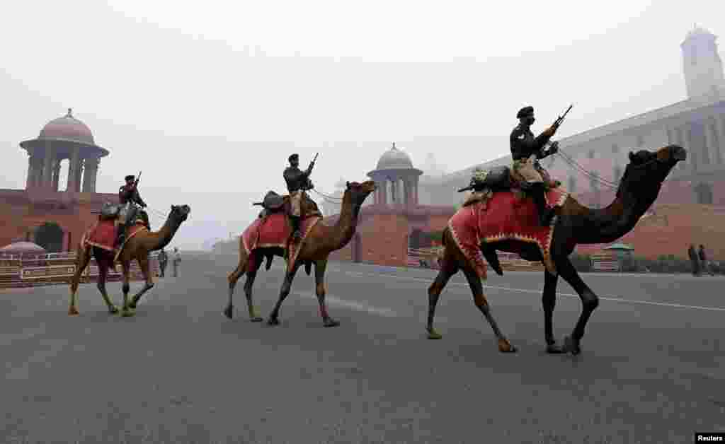 Members of the Indian Border Security Force (BSF) ride their camels during rehearsals for the Republic Day parade on a winter morning in New Delhi, India.