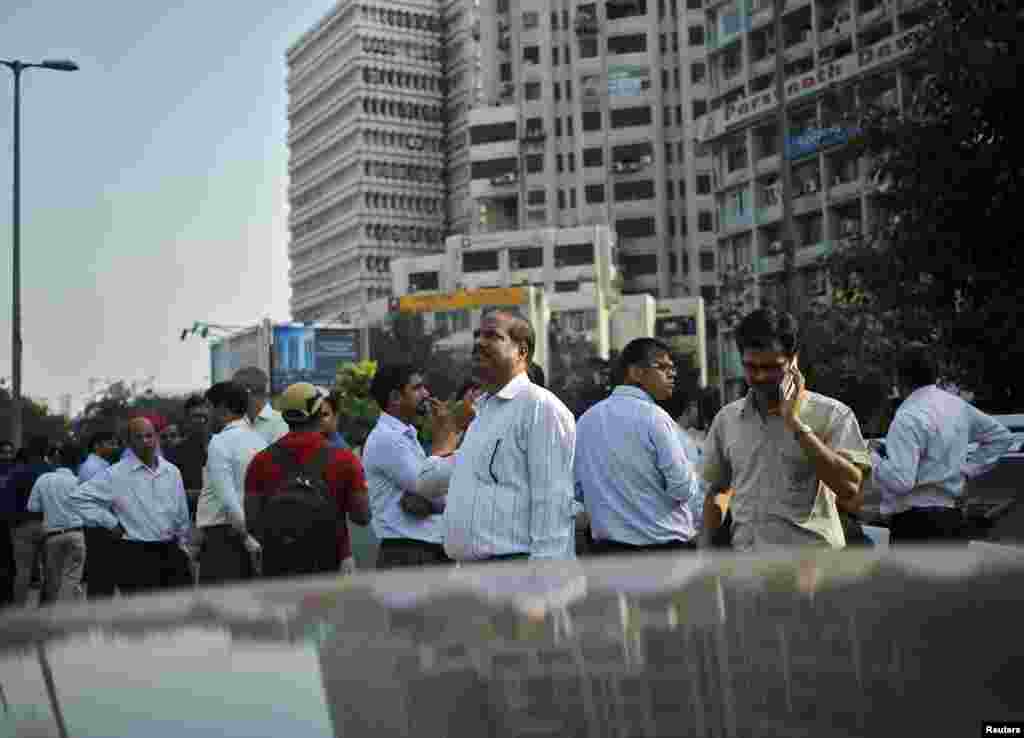 People vacate buildings following a powerful earthquake, in New Delhi, India, Oct. 26, 2015.