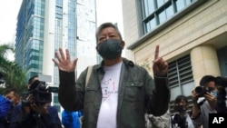 Pro-democracy activist Lee Cheuk-yan gestures before his sentencing in Hong Kong, April 16, 2021. A court sentenced five leading pro-democracy advocates to up to 18 months in prison for organizing a march during the 2019 anti-government protests.