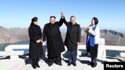 朝鲜领导人金正恩和韩国总统文在寅站在朝鲜白头山上合影。（2018年9月20日）