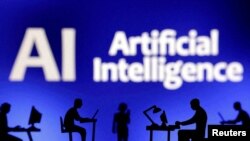FILE—Figurines with computers and smartphones are seen in front of the words "Artificial Intelligence AI" in this illustration taken, February 19, 2024.