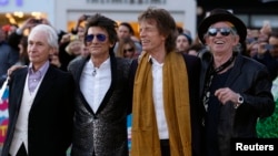 Members of the Rolling Stones (L-R) Charlie Watts, Ronnie Wood, Mick Jagger and Keith Richards arrive for the "Exhibitionism" opening night gala at the Saatchi Gallery in London, April 4, 2016.