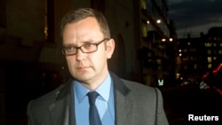 Former News of the World editor Andy Coulson (R) leaves the Old Bailey courthouse in London, England, Oct. 30, 2013. 