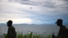 A United Nations helicopter flies over the Lake Kivu as M23 rebels walk along the shore in the city of Goma, east of the Democratic Republic of the Congo. Taken Nov.20, 2012. 
