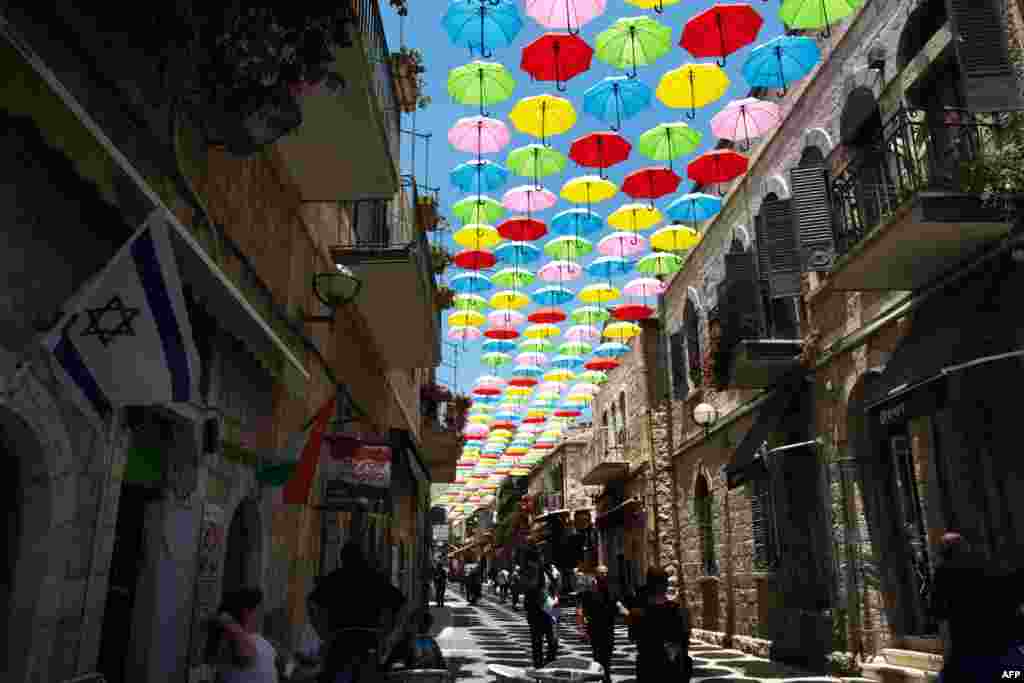 Around 1,000 colored umbrellas decorate a main pedestrian street in Jerusalem as the city&#39;s municipality opens more attractions and cultural activities in an effort to bring tourists and locals to visit the city.