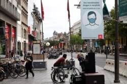 A sign reading "wearing a mask is mandatory" is seen in a street amid the coronavirus disease (COVID-19) outbreak in Antwerp, Belgium, July 27, 2020.