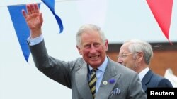 FILE - Britain's Prince Charles waves to the crowd during a visit to the harbour in Bridlington, northern England.