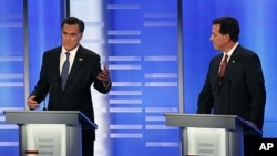 Former Massachusetts Gov. Mitt Romney, left, and former Pennsylvania Sen. Rick Santorum during a Republican presidential candidate debate at Saint Anselm College in Manchester, New Hampshire, January 7, 2012.