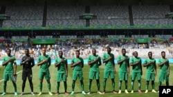 FILE - Nigeria's soccer team sing the national anthem before a match between Honduras and Nigeria at Mineirao stadium in Belo Horizonte, Brazil, Aug. 20, 2016.