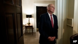 FILE - Then-White House Chief of Staff John Kelly listens as President Donald Trump speaks during a meeting in the Cabinet Room of the White House, in Washington, Dec. 13, 2018.