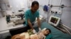 FILE - A nurse checks a boy at a hospital intensive care unit in Sanaa, Yemen, September 27, 2016.
