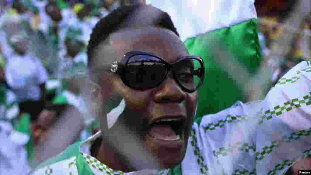 A supporter of Nigeria's football team celebrates their 2- 1 victory over Ethiopia in their 2014 World Cup qualifying soccer match.