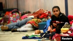 Venezuelan migrants wait at the Binational Border Service Center of Peru, on the border with Ecuador, in Tumbes, Peru, Aug. 25, 2018.