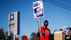 A member of the United Auto Workers walks the picket line at the General Motors Romulus Powertrain plant in Romulus, Michigan, Oct. 9, 2019.
