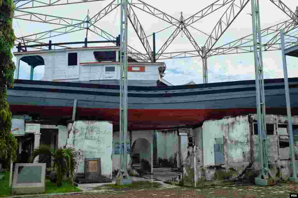 A fishing boat carried by the tsunami which came to rest atop a house. Fifty-six people took refuge in the boat from rising waters. (Steve Herman/VOA News)