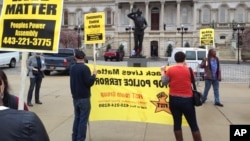Demonstrators protest the death of Freddie Gray outside Baltimore City Hall, April 20, 2015. Gray died Sunday, a week after he was rushed to the hospital with spinal injuries following an encounter with four Baltimore police officers.