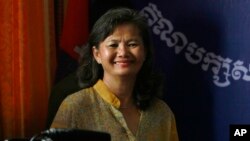 Parliament member Mu Sochua smiles before a press conference at her party headquarters, in Phnom Penh, Cambodia, Sunday, Sept. 8, 2013.