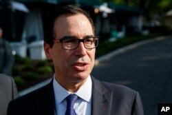 Treasury Secretary Steve Mnuchin talks with reporters about trade with China outside of the White House, May 21, 2018, in Washington.