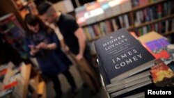 FILE - Copies of former FBI director James Comey's book "A Higher Loyalty" are seen at Kramerbooks book store in Washington D.C., April 17, 2018. 