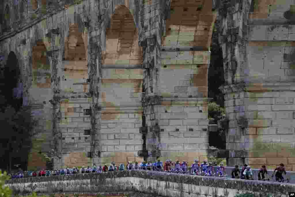 The pack rides next to the Pont du Gard during the sixteenth stage of the Tour de France cycling race over 117 kilometers (73 miles) with start and finish in Nimes, France.