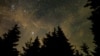 In this 30 second exposure, a meteor streaks across the sky during the annual Perseid meteor shower, Wednesday, Aug. 11, 2021, in Spruce Knob, West Virginia. Photo Credit: (NASA/Bill Ingalls)