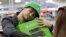 FILE - A man hugs his new Xbox One after he purchased it at a Best Buy, Nov. 22, 2013, in Evanston, Illinois. 