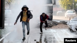 Riot police use a water cannon to disperse demonstrators during a protest against the curfew in Sur district, in the southeastern city of Diyarbakir, Turkey, Dec.18, 2015.