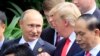 FILE - Russian President Vladimir Putin and U.S. President Donald Trump talk as they arrive for the family photo session during the Asia-Pacific Economic Cooperation summit in Danang, Vietnam, Nov. 11, 2017.