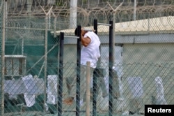 FILE - A detainee does pull-ups inside an exercise area at the U.S. detention facility at Guantanamo Bay, Cuba, April 27, 2010.