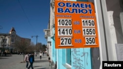 A sign displaying currency rates is seen in Simferopol, Crimea March 22, 2014.