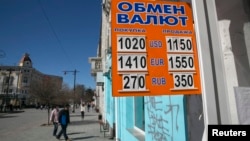 A sign displaying currency rates is seen in Simferopol, Crimea March 22, 2014.
