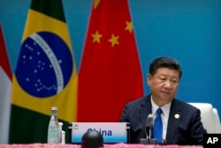 Chinese President Xi Jinping listens to a speech during the Dialogue of Emerging Market and Developing Countries in Xiamen in southeastern China's Fujian Province, Tuesday, Sept. 5, 2017.