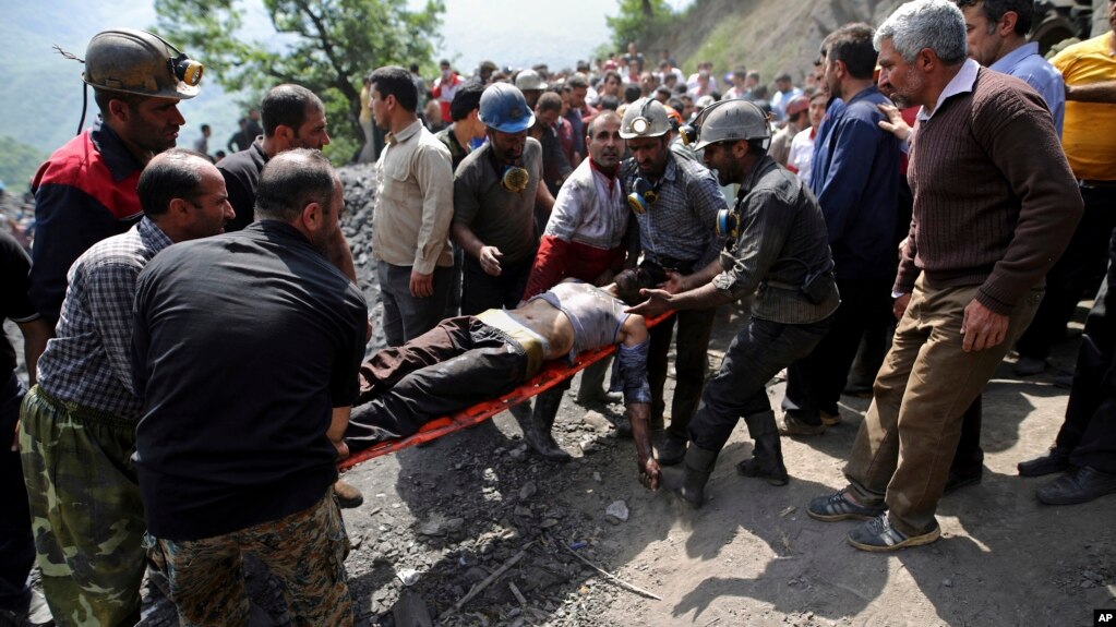 In this picture released by the Tasnim News Agency, miners and rescue personnel carry an injured mine worker after a coal mine explosion, near Azadshahr in northern Iran, May, 3, 2017. 