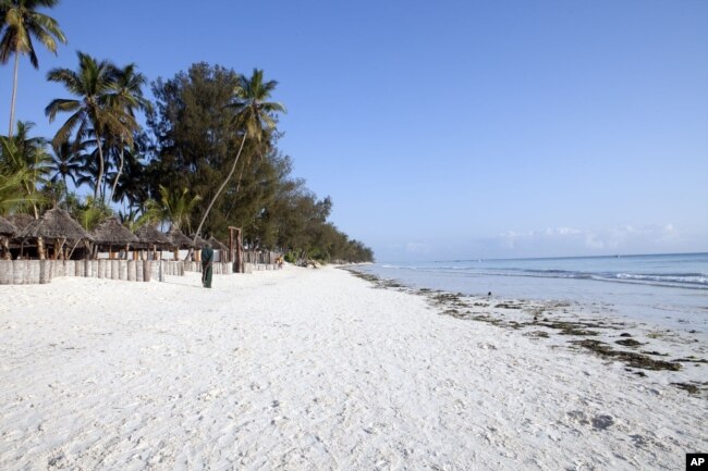 A villager walks along a deserted beach near a seaside resort on the East African archipelago of Zanzibar, Oct. 12, 2010.