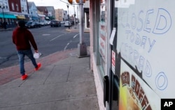 A sign alerts customers a bakery is closed for the day as part of an immigration protest, Feb. 16, 2017, in Perth Amboy, New Jersey.