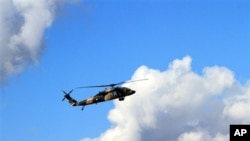 A Turkish military helicopter flies toward Iraq near Cukurca, Hakkari, Turkey, at the border with Iraq, Thursday, Oct. 20, 2011. About 10,000 elite Turkish soldiers were taking part in a ground offensive against Kurdish rebels in southeastern Turkey and a